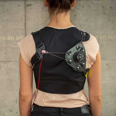 woman wearing a shoulder exoskelleton