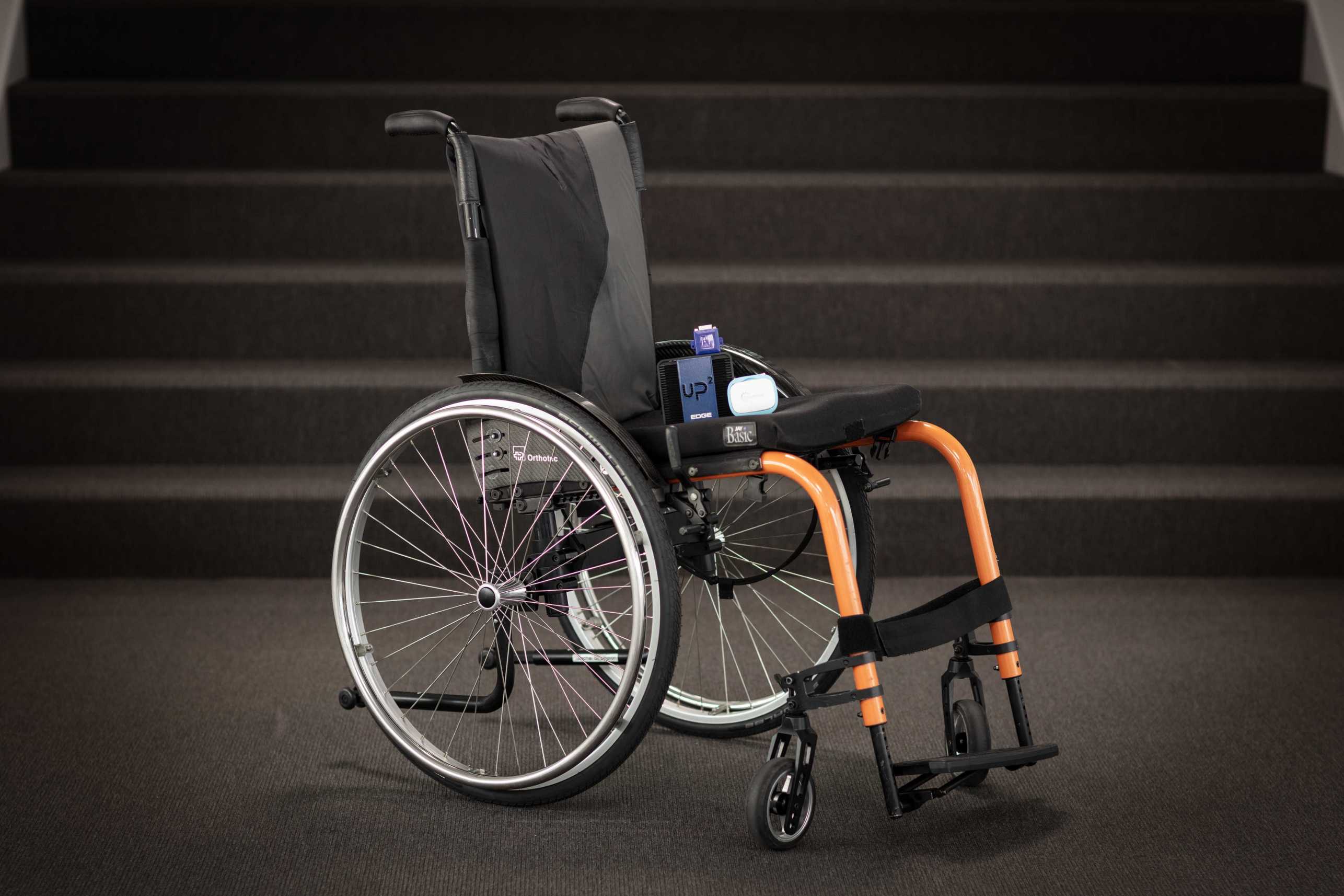 Enlarged view: A manual wheelchair with an embedded computer, a two other sensors on the seat 